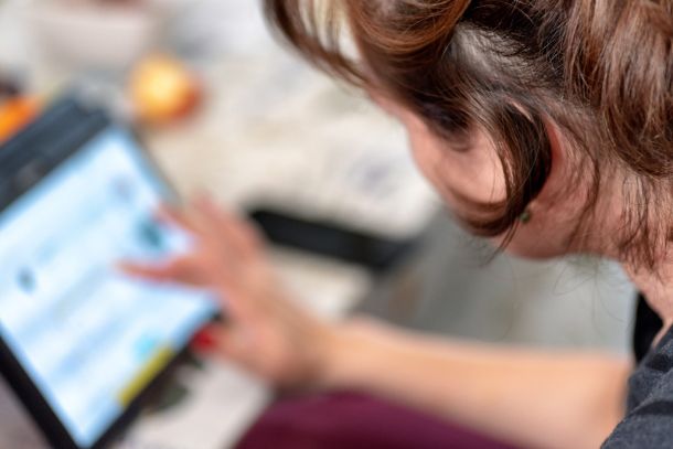 woman using finger on smart tablet