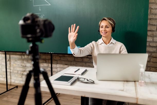 Online teacher waiving hand